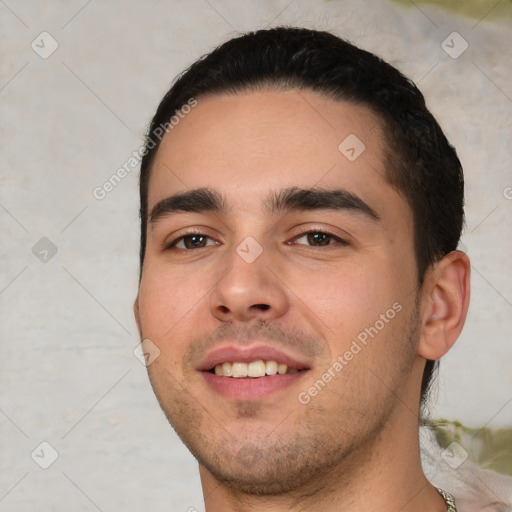 Joyful white young-adult male with short  black hair and brown eyes