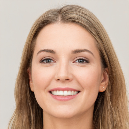 Joyful white young-adult female with long  brown hair and grey eyes