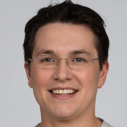 Joyful white adult male with short  brown hair and grey eyes