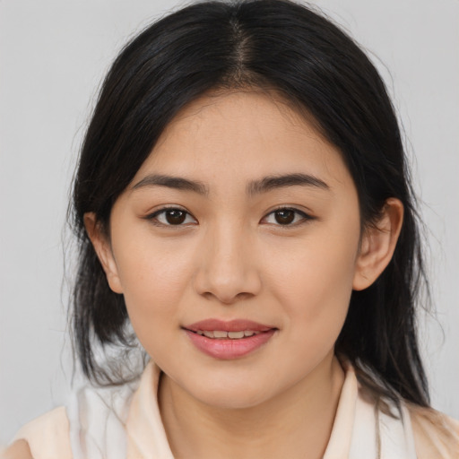 Joyful asian young-adult female with medium  brown hair and brown eyes