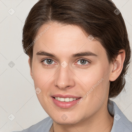 Joyful white young-adult female with medium  brown hair and grey eyes