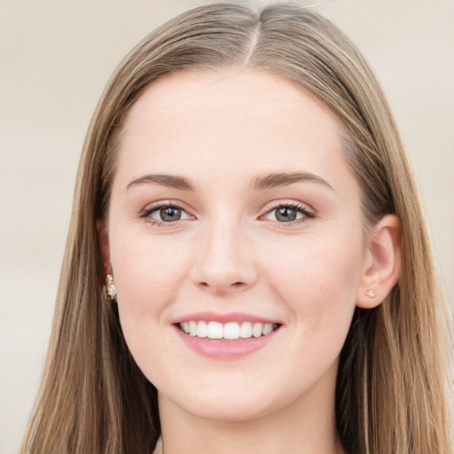 Joyful white young-adult female with long  brown hair and grey eyes