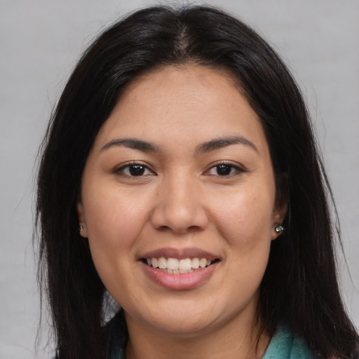 Joyful asian young-adult female with long  brown hair and brown eyes