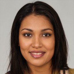 Joyful latino young-adult female with long  brown hair and brown eyes