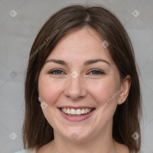 Joyful white adult female with medium  brown hair and brown eyes