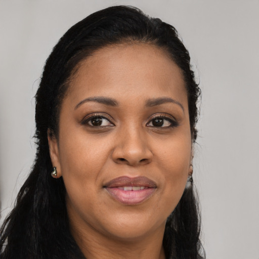 Joyful latino adult female with long  brown hair and brown eyes
