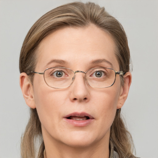 Joyful white adult female with long  brown hair and grey eyes