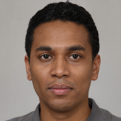 Neutral black young-adult male with short  black hair and brown eyes