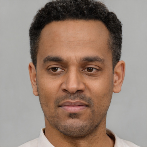 Neutral latino young-adult male with short  black hair and brown eyes
