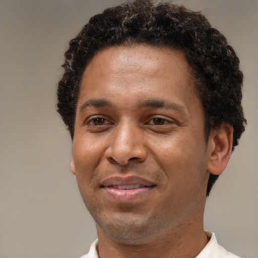 Joyful latino adult male with short  brown hair and brown eyes