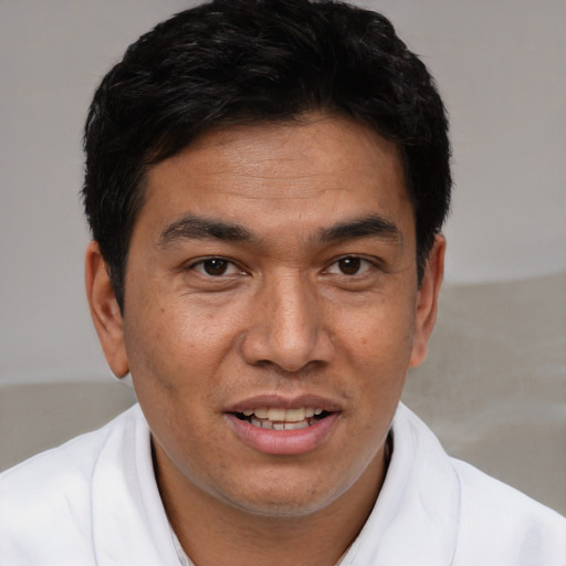 Joyful white adult male with short  brown hair and brown eyes