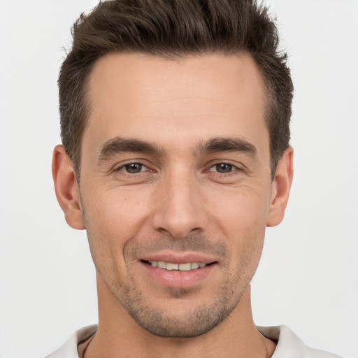 Joyful white young-adult male with short  brown hair and brown eyes