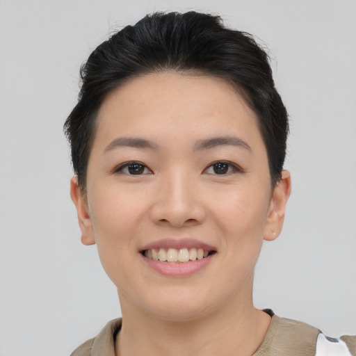 Joyful asian young-adult female with short  brown hair and brown eyes