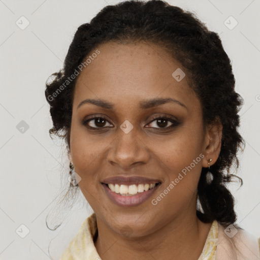 Joyful black young-adult female with long  brown hair and brown eyes