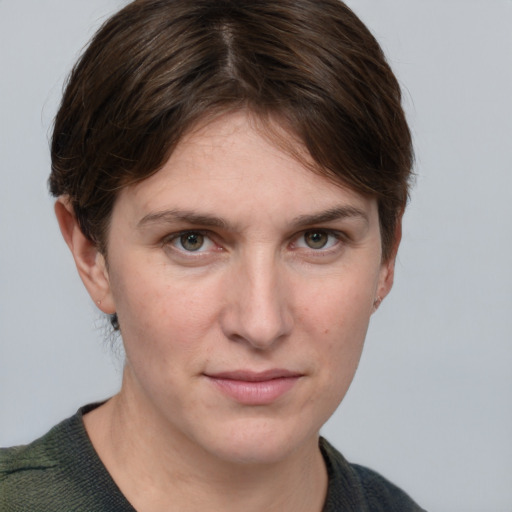 Joyful white young-adult female with short  brown hair and grey eyes