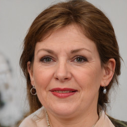 Joyful white adult female with medium  brown hair and brown eyes