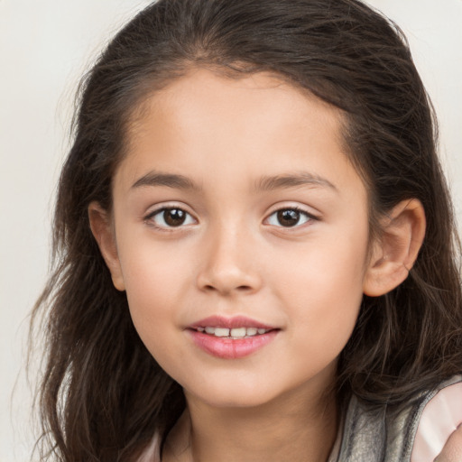 Joyful white child female with long  brown hair and brown eyes