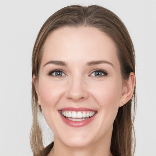 Joyful white young-adult female with long  brown hair and grey eyes