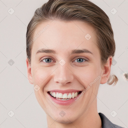 Joyful white young-adult female with short  brown hair and grey eyes