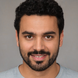 Joyful white young-adult male with short  black hair and brown eyes