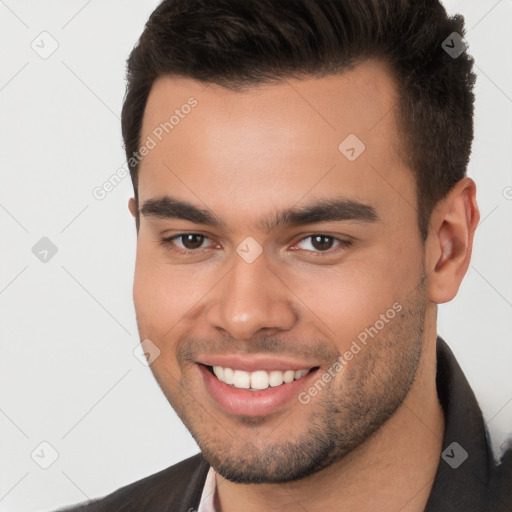 Joyful white young-adult male with short  brown hair and brown eyes