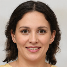 Joyful white adult female with medium  brown hair and brown eyes