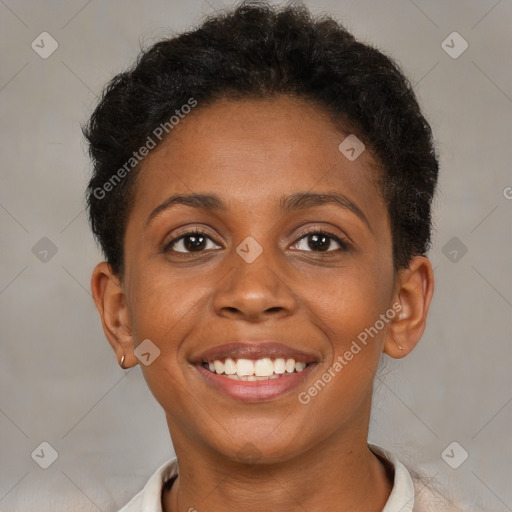 Joyful black young-adult female with short  brown hair and brown eyes