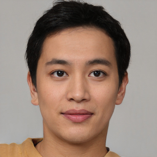 Joyful asian young-adult male with short  brown hair and brown eyes