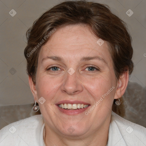 Joyful white adult female with medium  brown hair and blue eyes