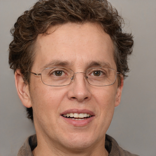 Joyful white adult male with short  brown hair and blue eyes