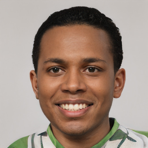 Joyful black young-adult male with short  black hair and brown eyes