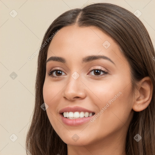 Joyful white young-adult female with long  brown hair and brown eyes