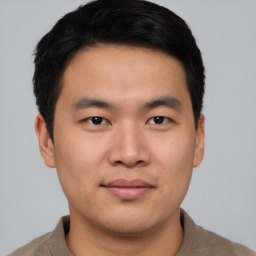 Joyful asian young-adult male with short  black hair and brown eyes