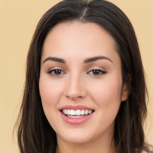 Joyful white young-adult female with long  brown hair and brown eyes