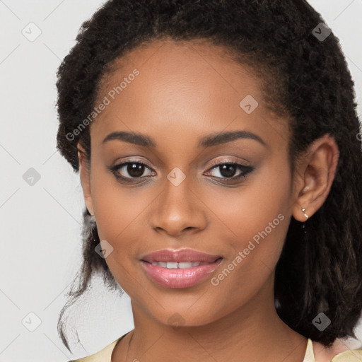 Joyful black young-adult female with long  brown hair and brown eyes