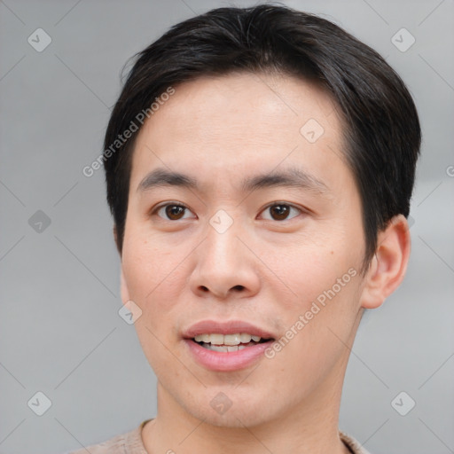 Joyful asian young-adult male with short  brown hair and brown eyes