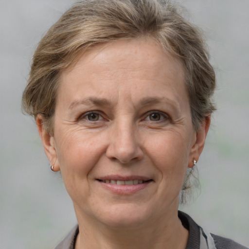 Joyful white adult female with medium  brown hair and grey eyes