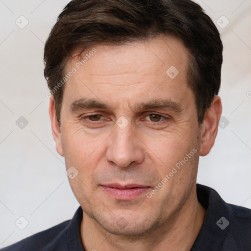 Joyful white adult male with short  brown hair and brown eyes