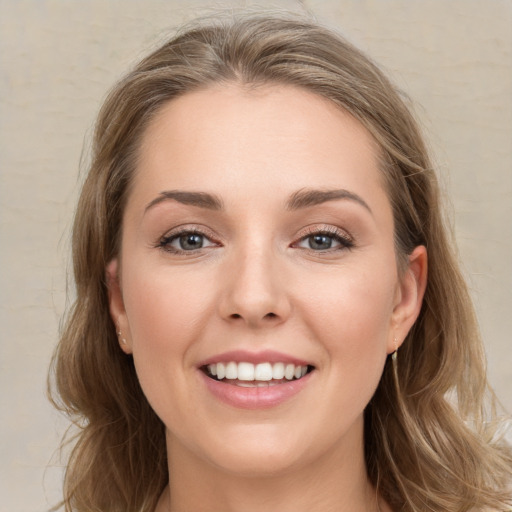 Joyful white young-adult female with long  brown hair and grey eyes