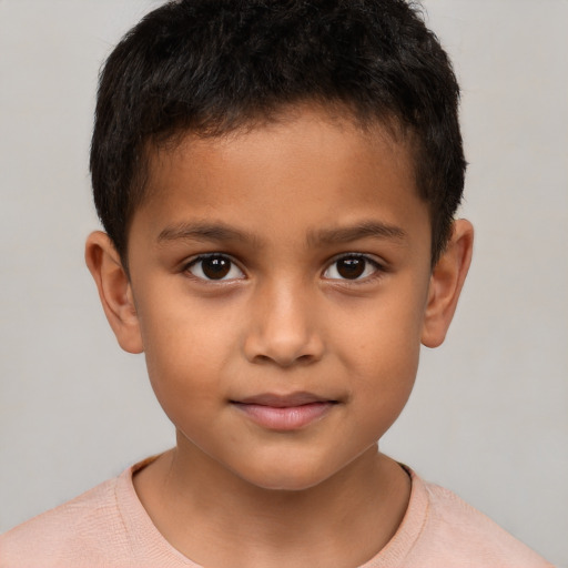 Joyful white child male with short  brown hair and brown eyes