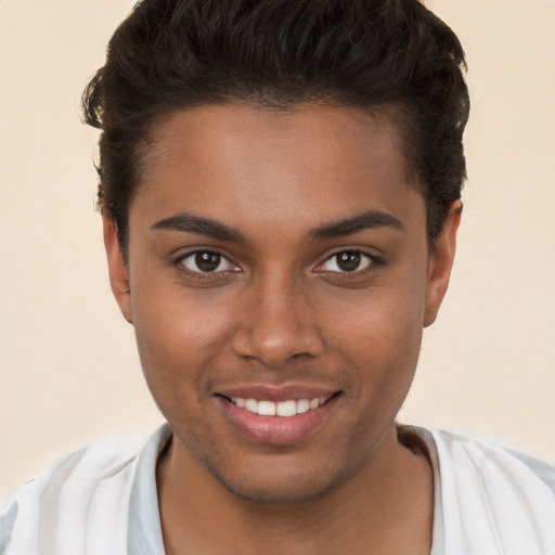 Joyful black young-adult male with short  brown hair and brown eyes