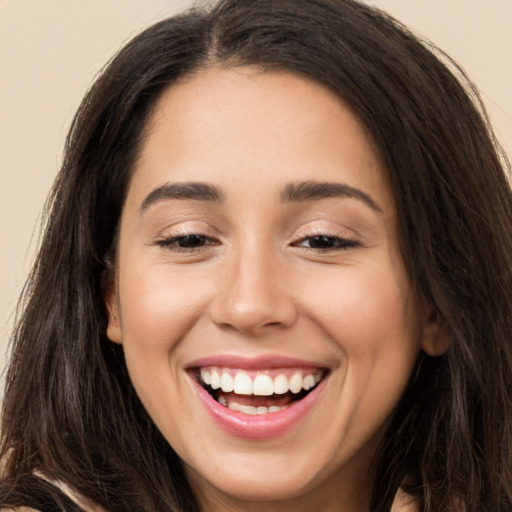 Joyful white young-adult female with long  brown hair and brown eyes