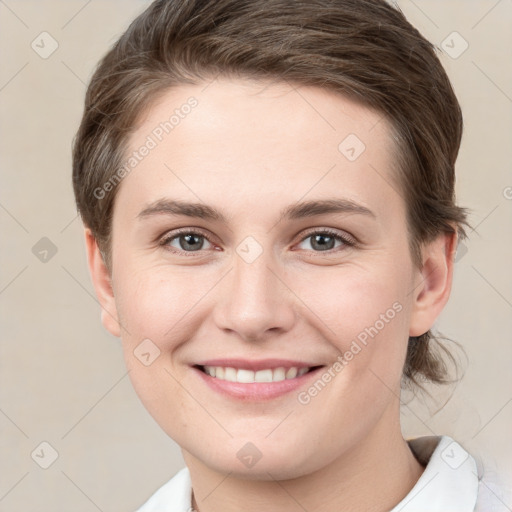 Joyful white young-adult female with short  brown hair and brown eyes