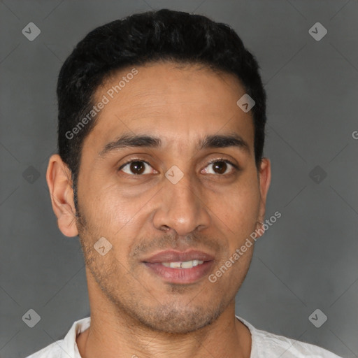 Joyful latino young-adult male with short  brown hair and brown eyes