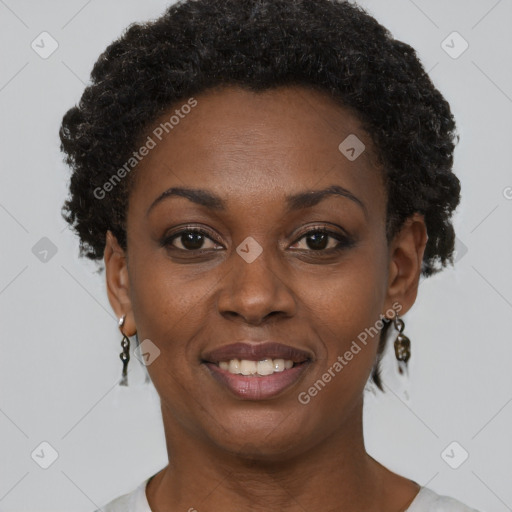 Joyful black young-adult female with short  black hair and brown eyes