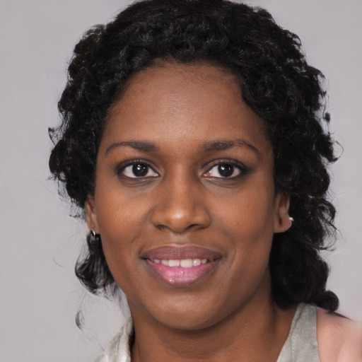Joyful black young-adult female with medium  black hair and brown eyes