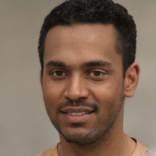 Joyful black young-adult male with short  black hair and brown eyes