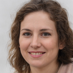 Joyful white adult female with long  brown hair and brown eyes