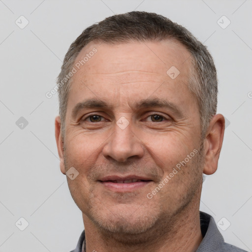 Joyful white adult male with short  brown hair and brown eyes