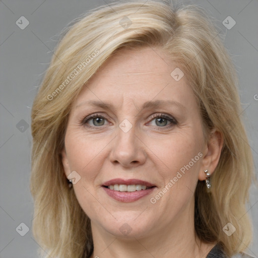 Joyful white adult female with medium  brown hair and blue eyes